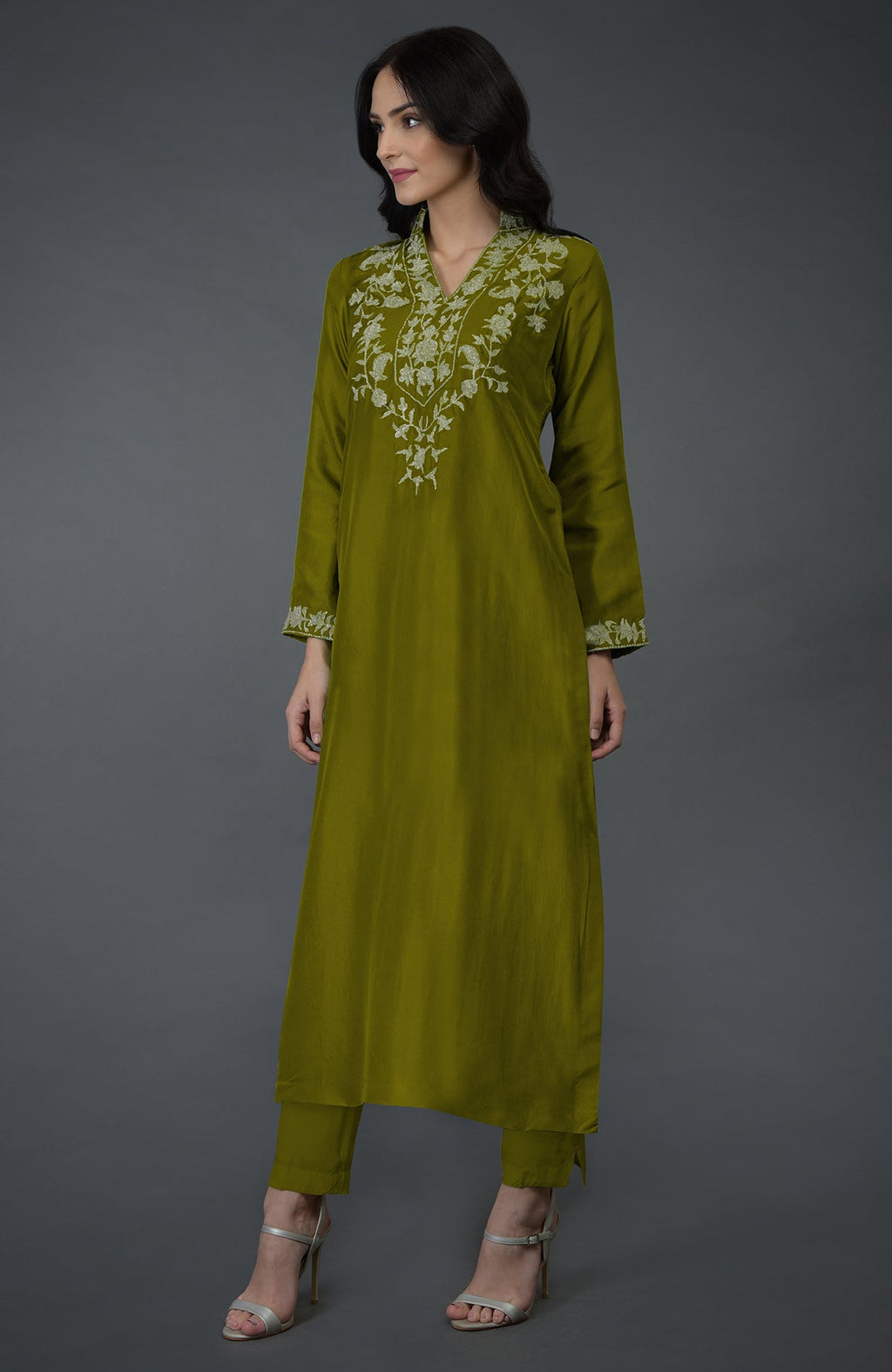 An olive Kashmiri tilla embroidered kurta set with a woman wearing it.
