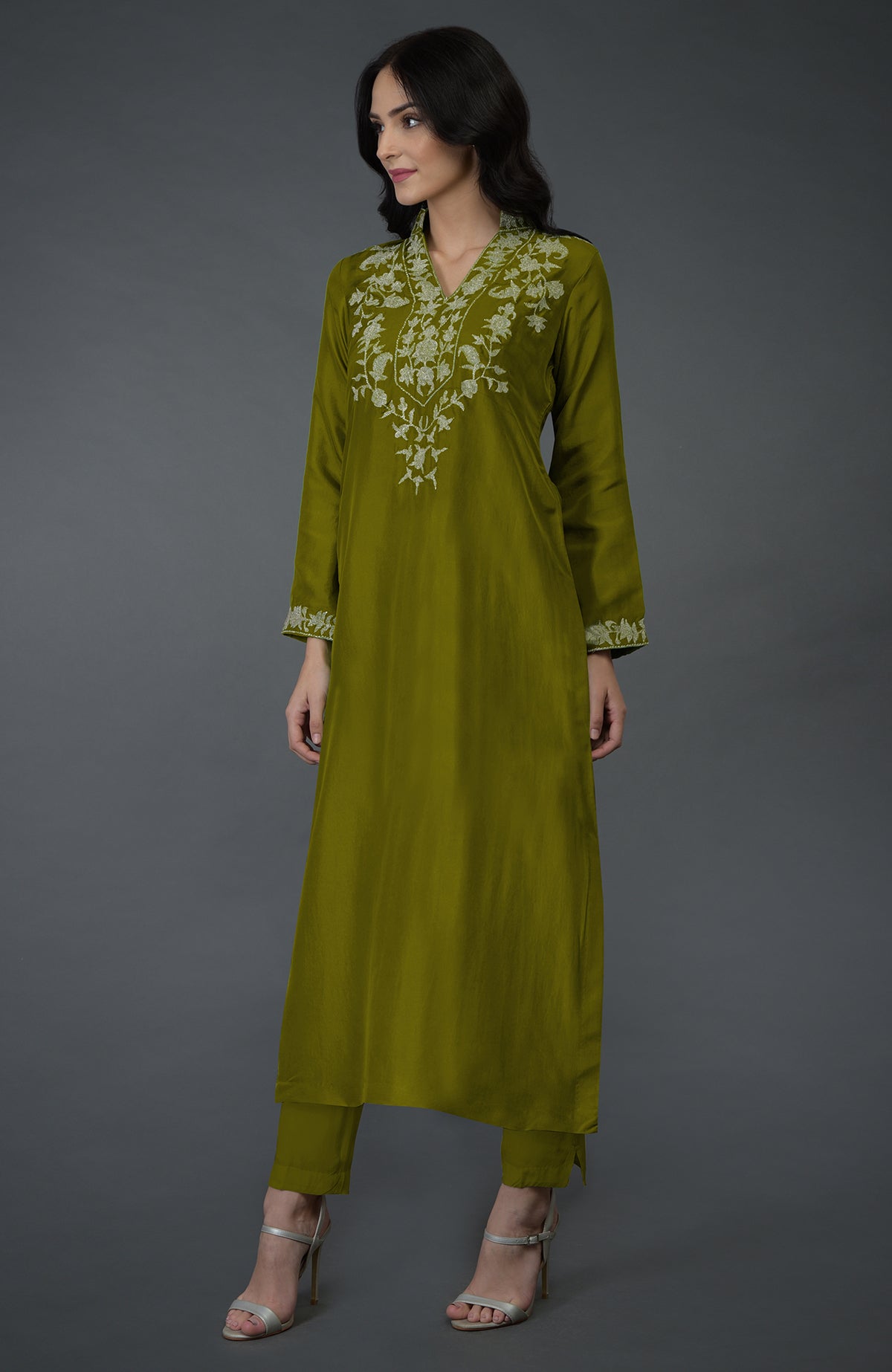 An olive Kashmiri tilla embroidered kurta set with a woman wearing it.