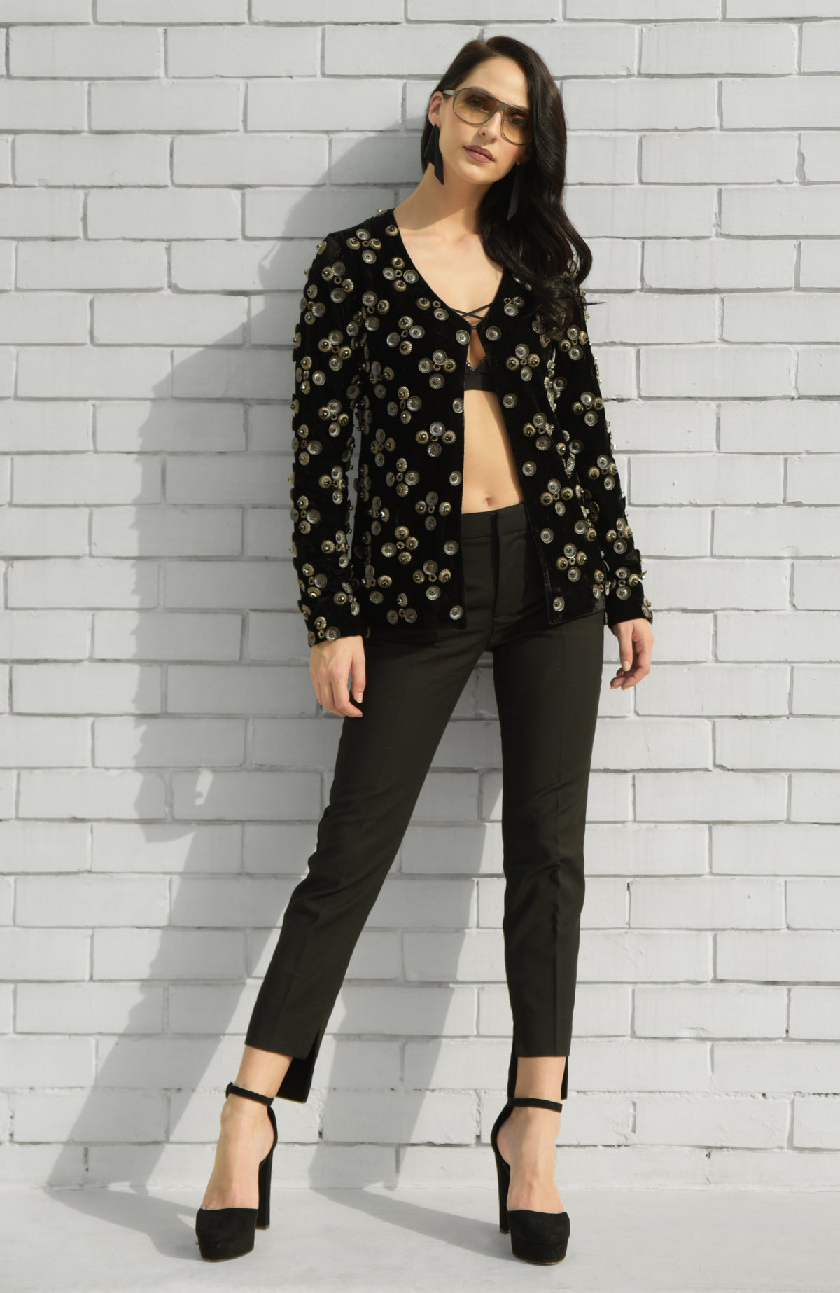 Black velvet jacket with metal studs, styled with black trousers and a bralette.