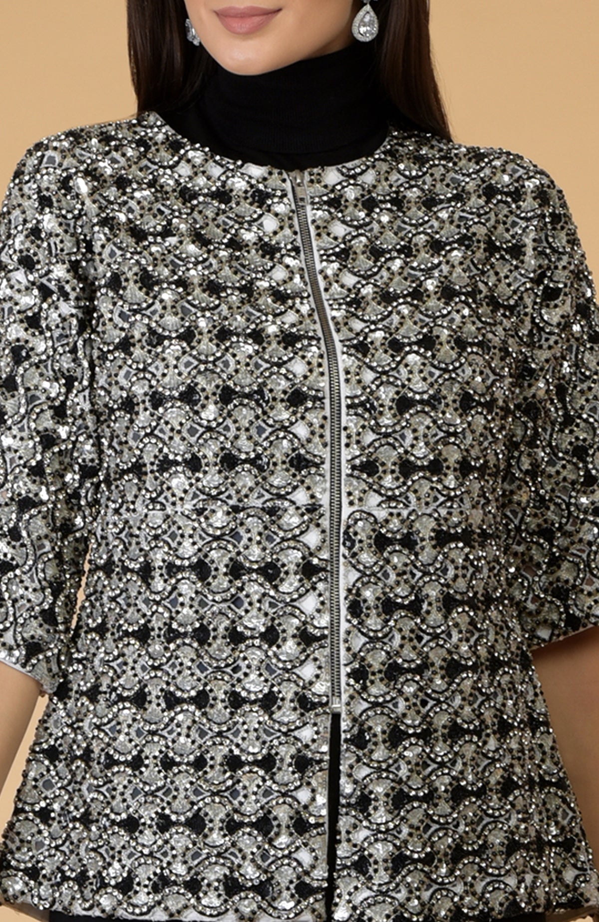 Black empire crystal beads and sequin hand-embroidered jacket with a zipper closure.