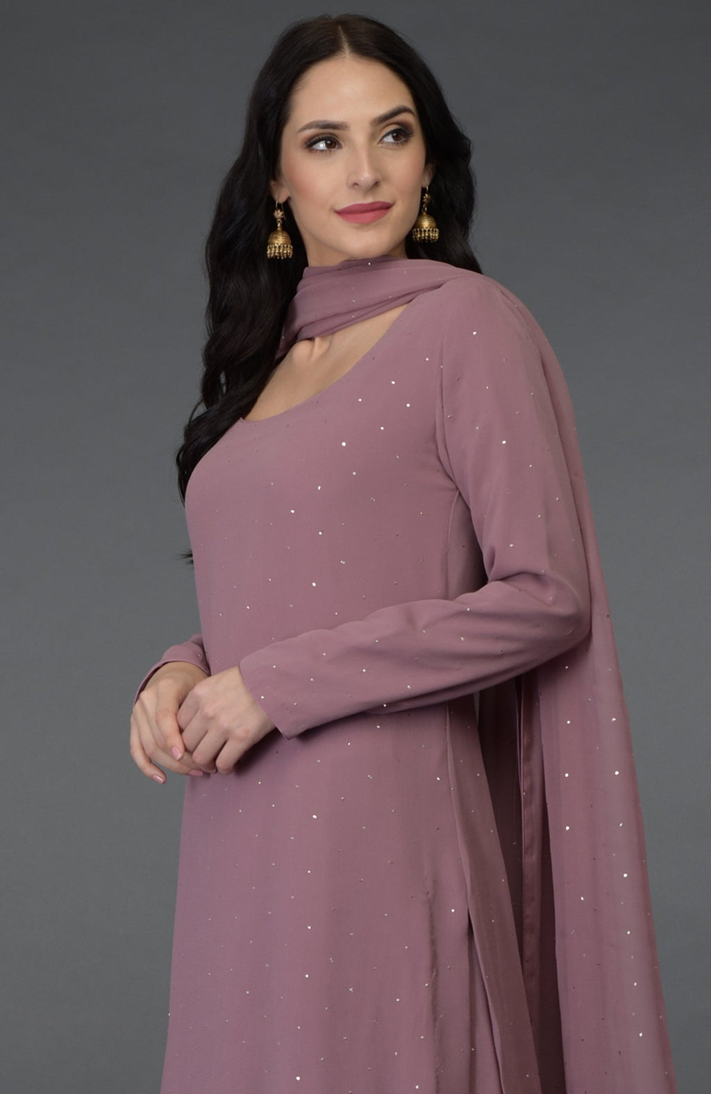 Lilac handcrafted mukaish farshi palazzo suit with a woman modeling it.