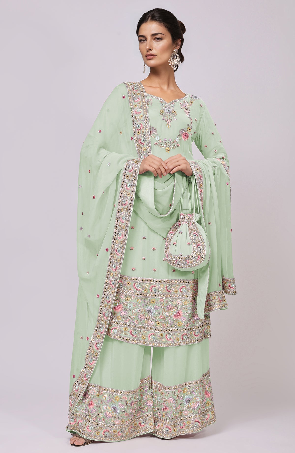 Sage green sharara set with intricate resham, zardozi, and mirror embroidery.