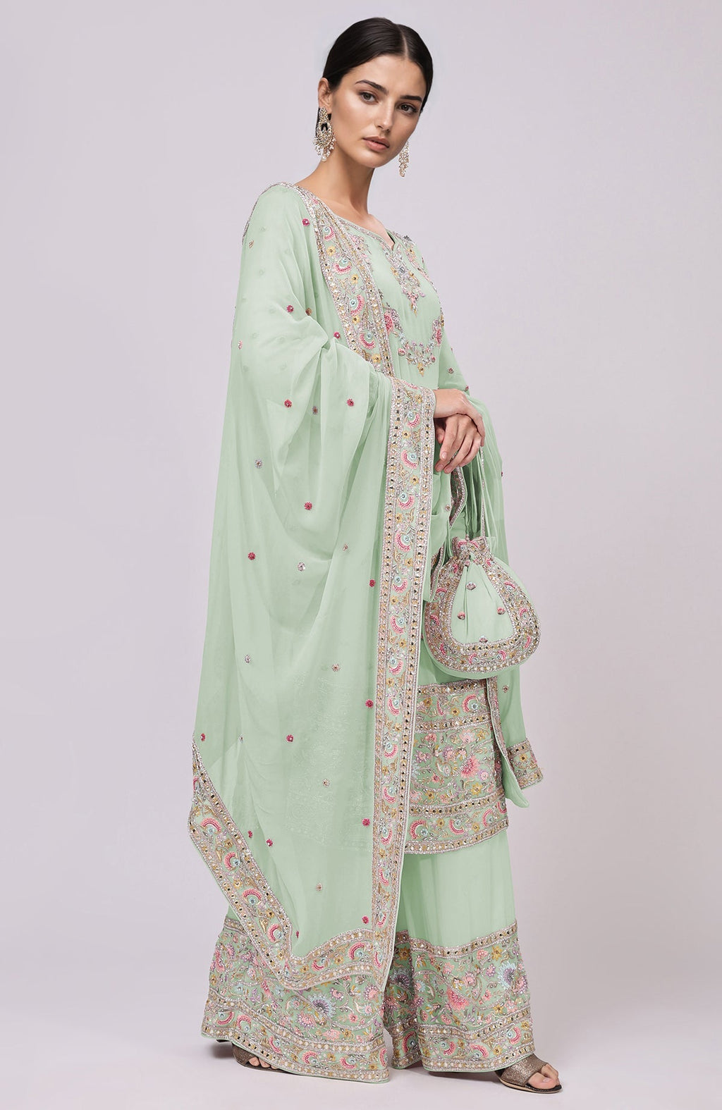 Sage green sharara set with resham and zardozi embroidery, matching dupatta and potli bag.