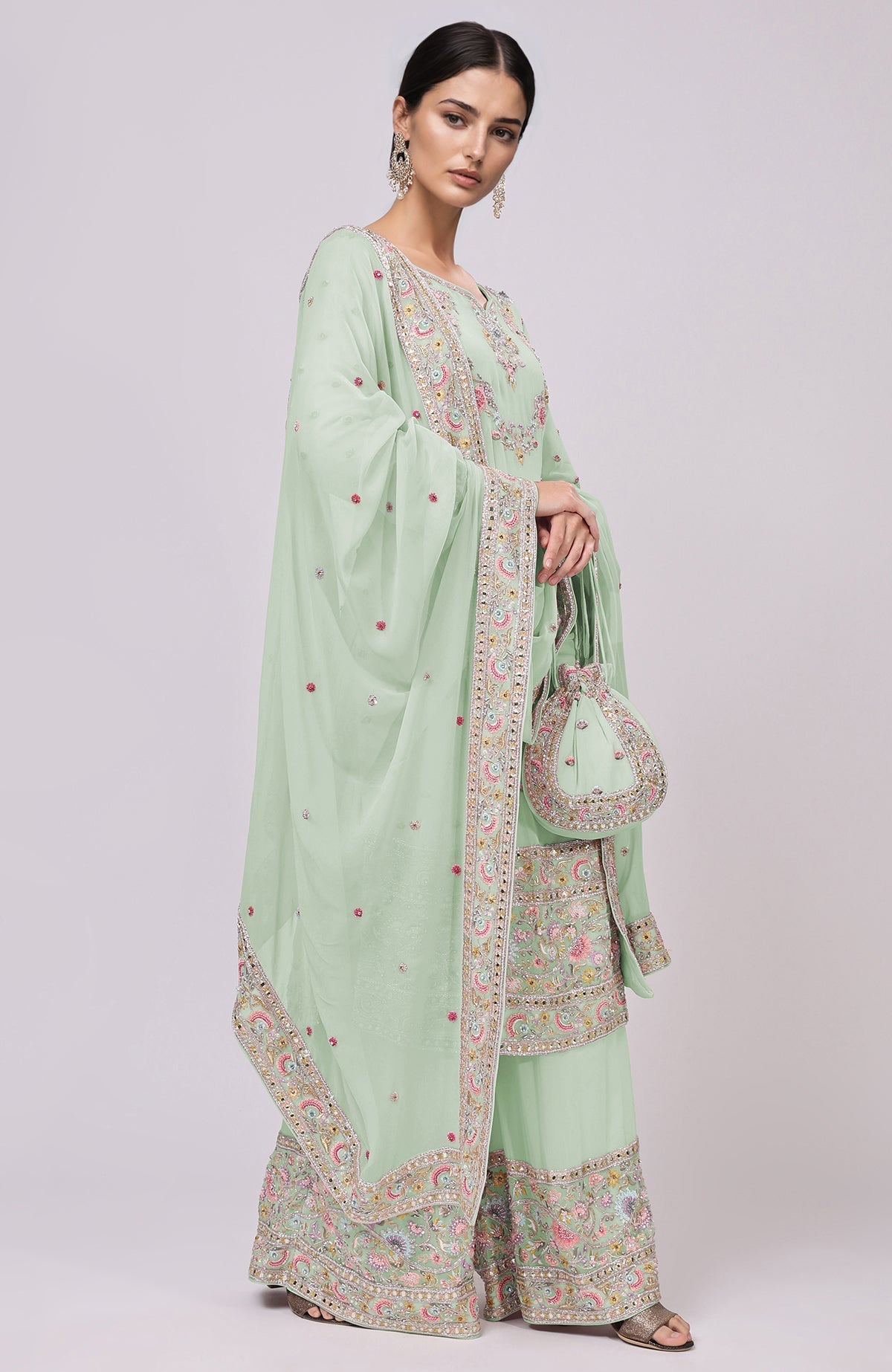 Sage green sharara set with resham and zardozi embroidery, matching dupatta and potli bag.
