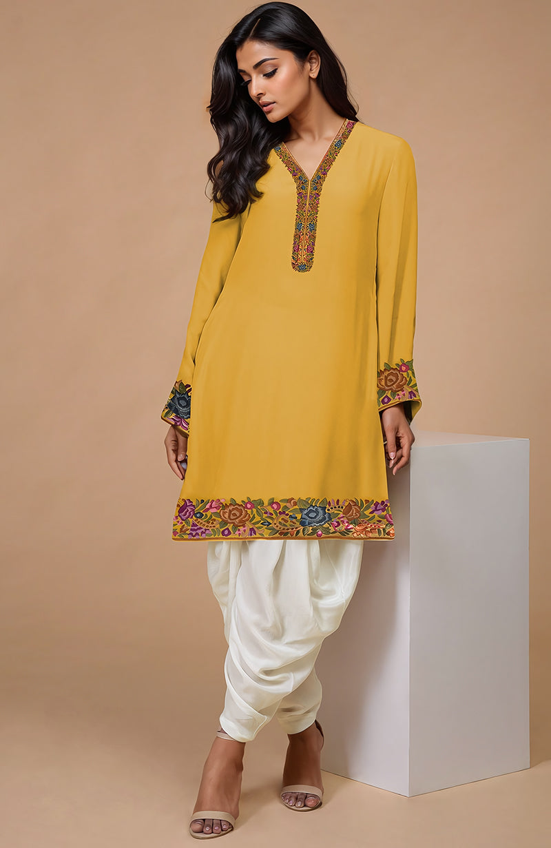 A woman models a calendula Parsi Gara embroidered Patiala pants suit.