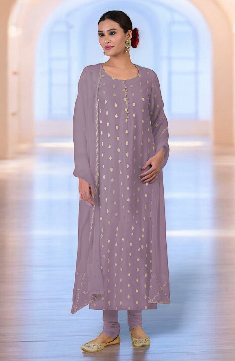 A woman models a withered rose Banarasi kurta set with gold bootah and aari tilla embroidery.