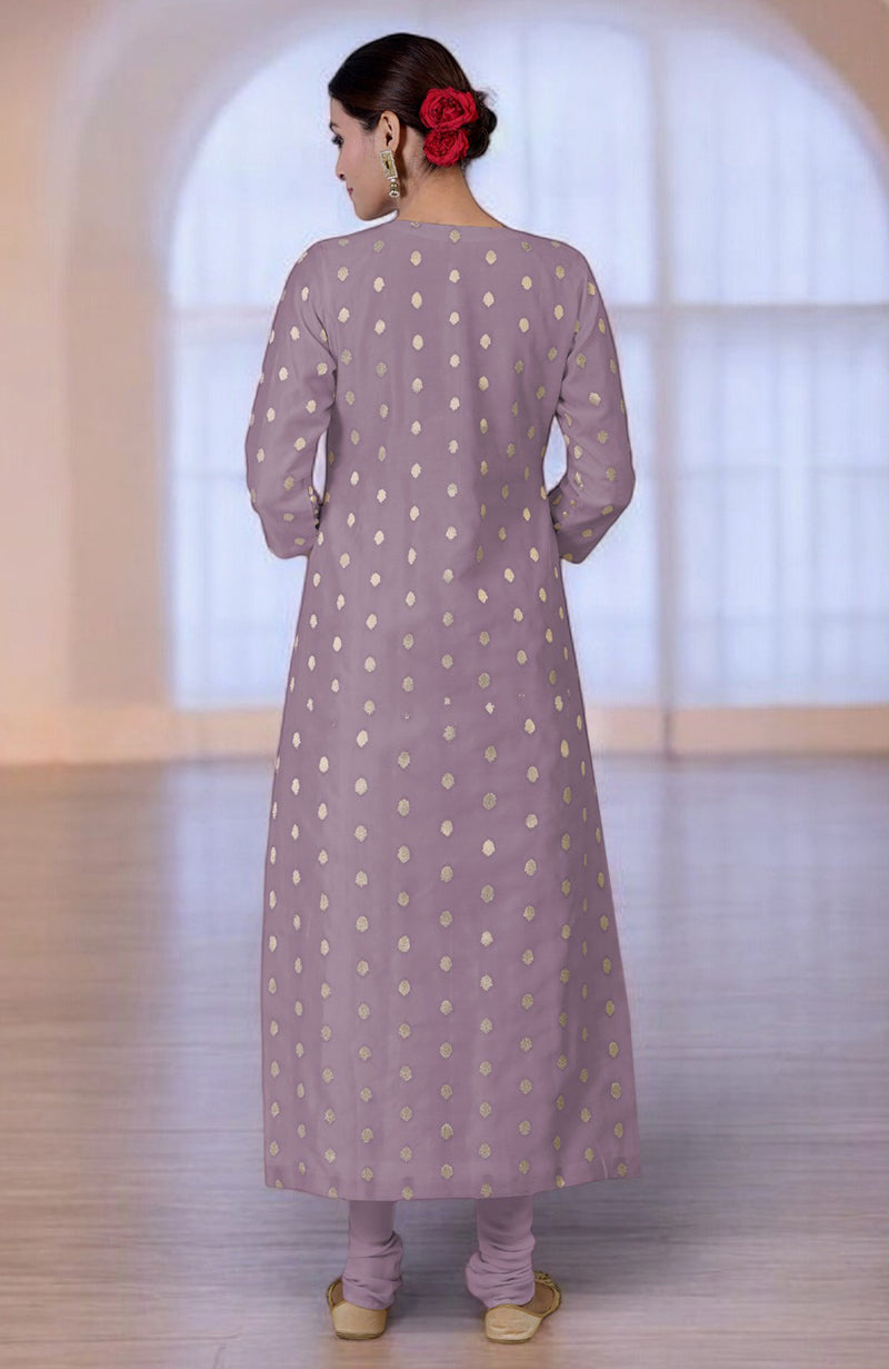 Woman in an elderberry Banarasi kurta set with gold polka dots.