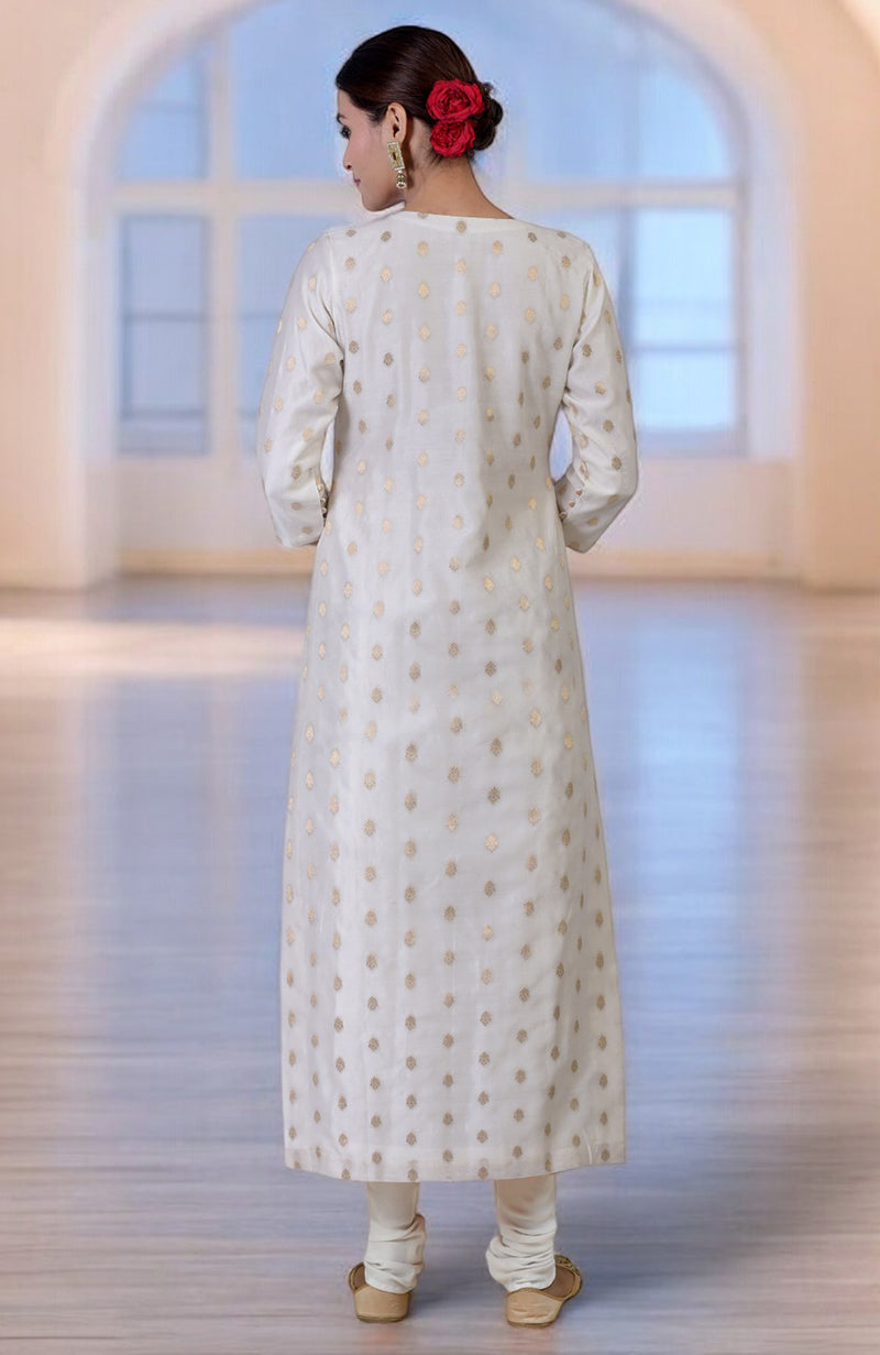 An elegant woman in an ivory Banarasi kurta set with gold bootah embroidery.