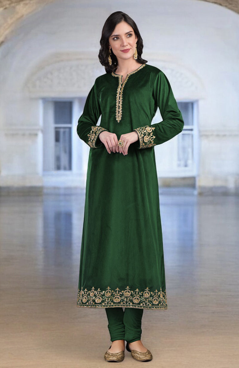 A woman models a dark green velvet kurta set with gold embroidery.