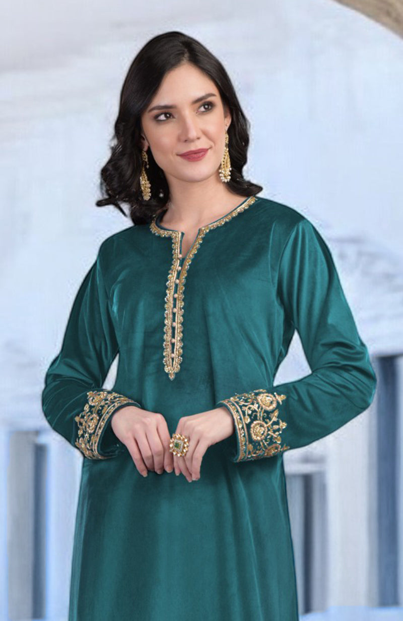 A woman models a peacock blue velvet kurta with gold zardozi embroidery.