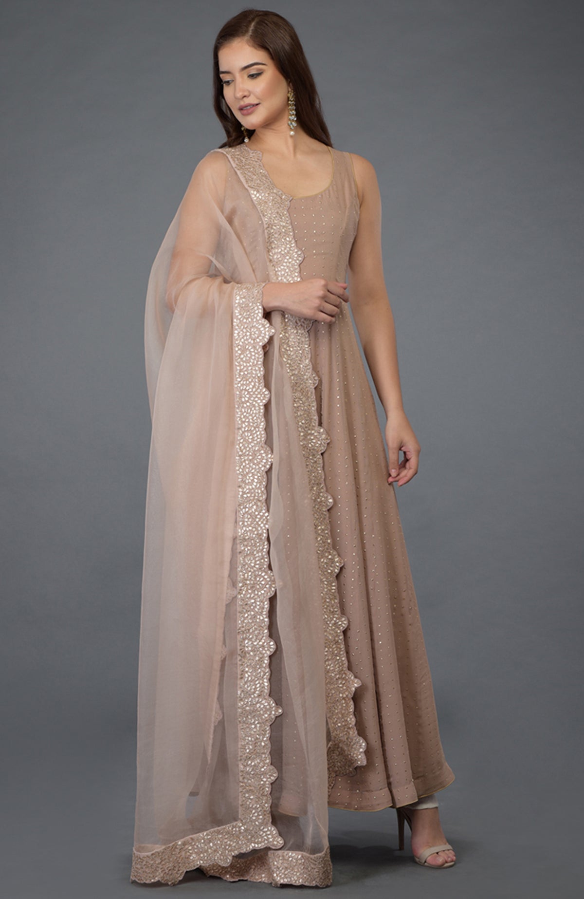 Oyster pink Anarkali suit with gold dot embossing and a matching gota patti embroidered dupatta.