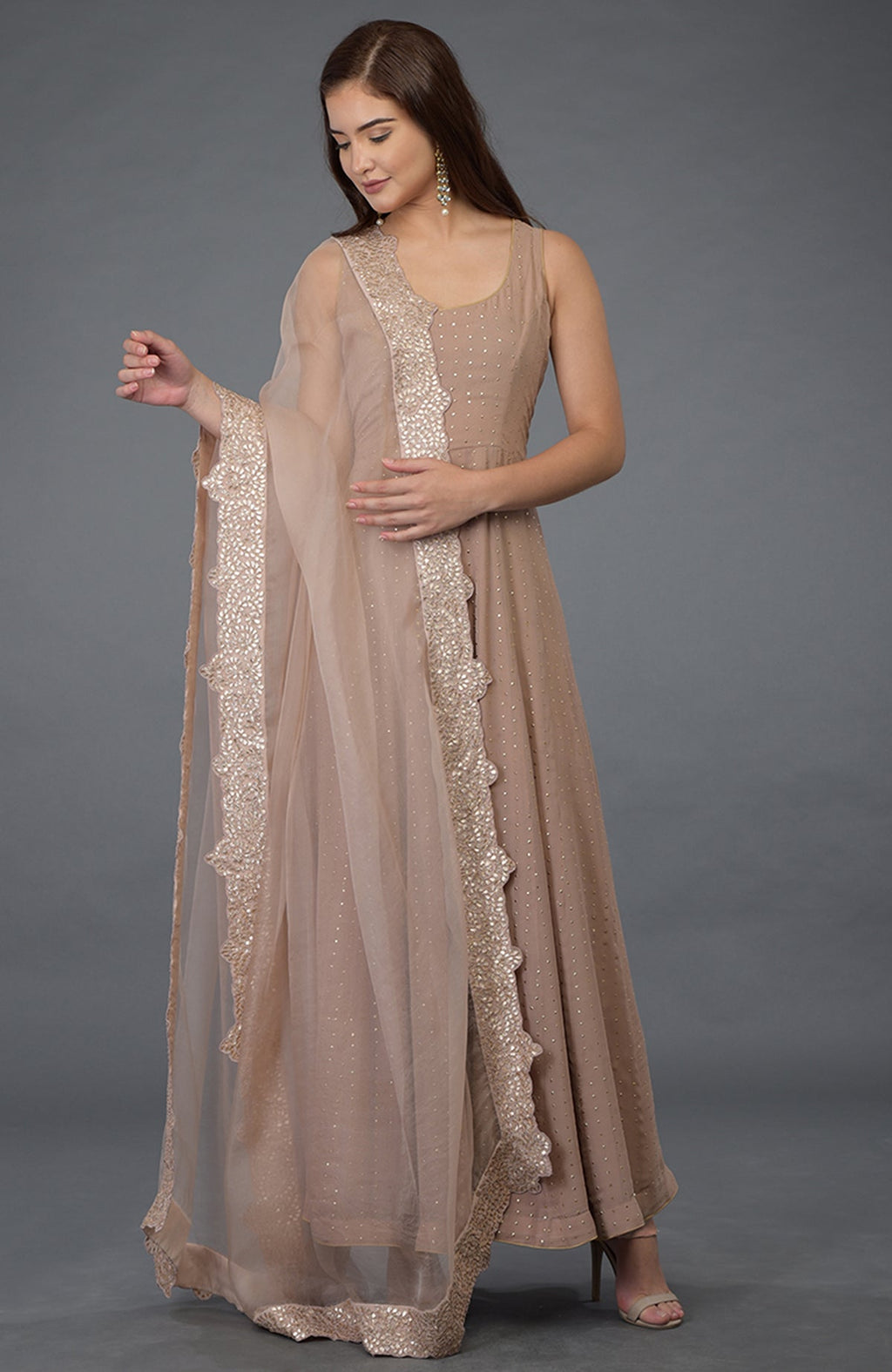 An oyster pink Anarkali suit with a gold dot pattern and a matching embroidered dupatta.