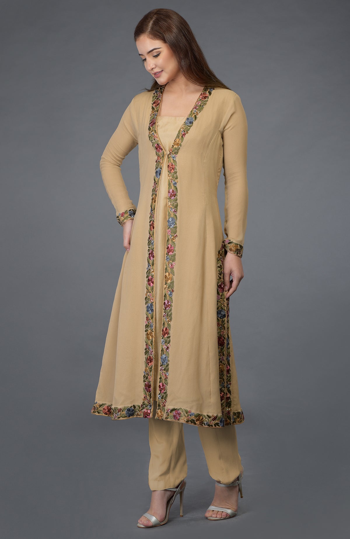 Beige Parsi Gara embroidered overlay suit with floral borders and matching pants.