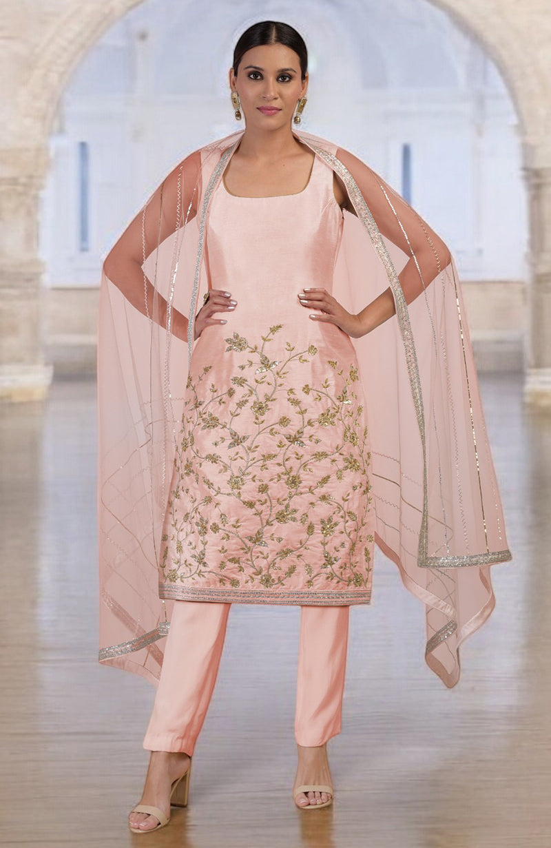 Rose gold hand-embroidered kurta set with a sheer dupatta and matching pants.