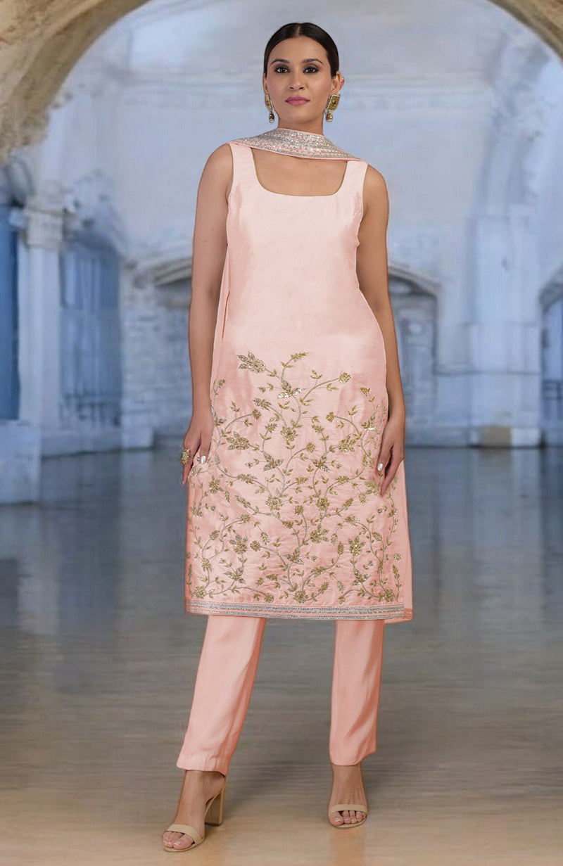 Rose gold hand-embroidered raw silk kurta set with floral motifs and matching pants.