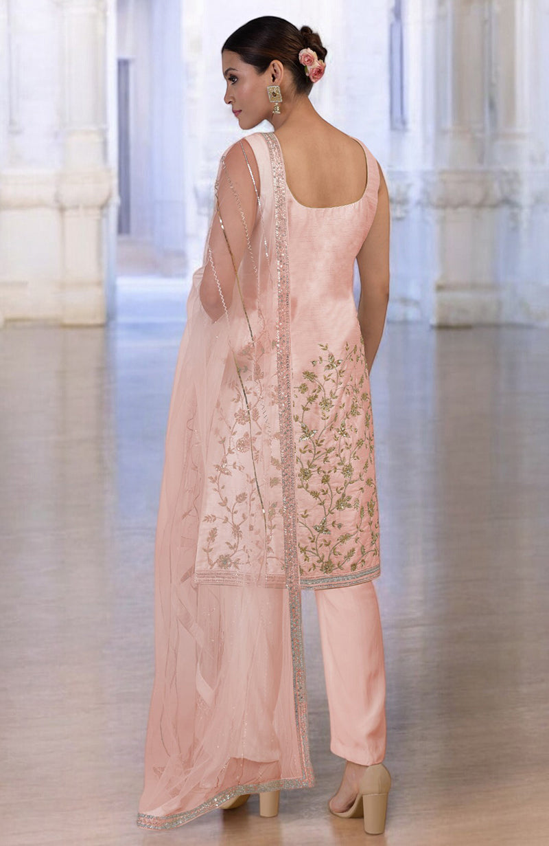 Rose gold hand-embroidered kurta set with floral motifs, paired with matching pants and dupatta.