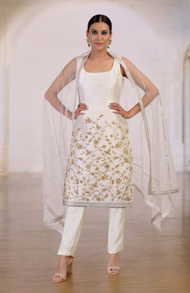 White-gold hand-embroidered kurta set with a sheer dupatta.