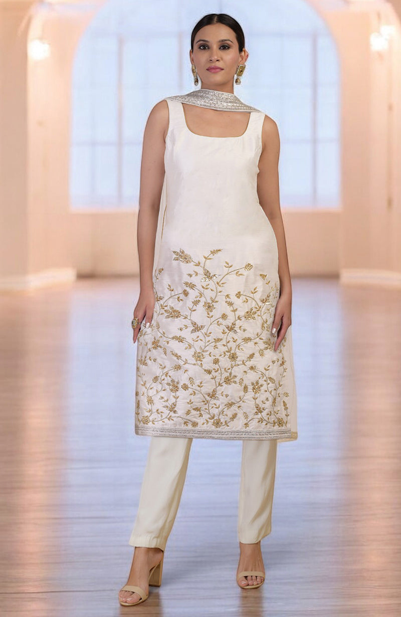 White-gold hand-embroidered kurta set with a sleeveless kurta, pants, and dupatta.