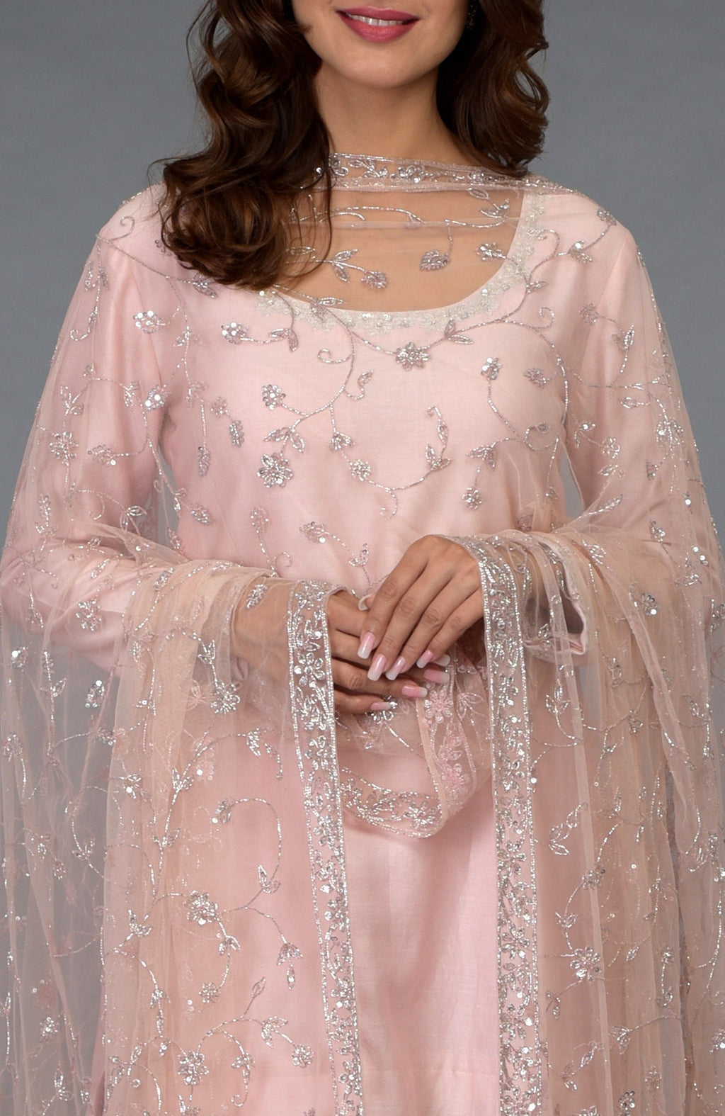 Pink-silver gharara suit with zari, sequin, and crystal embroidery.