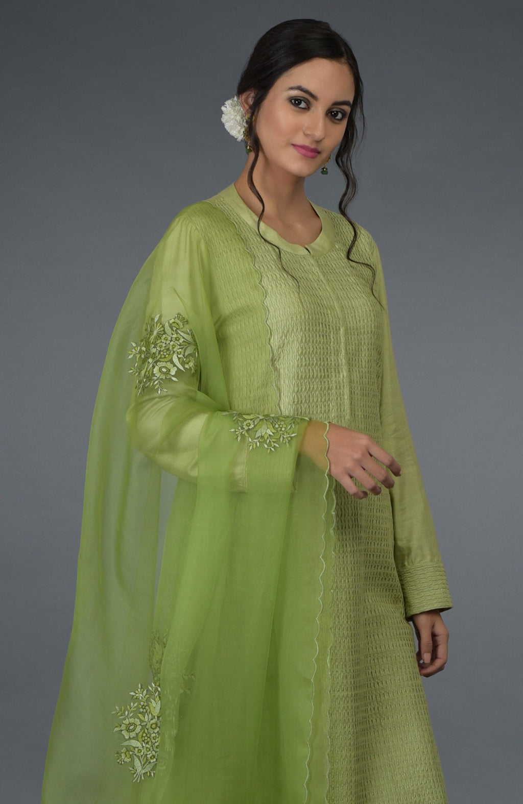 Pista green pintuck silk kurta set with an embroidered organza silk dupatta.