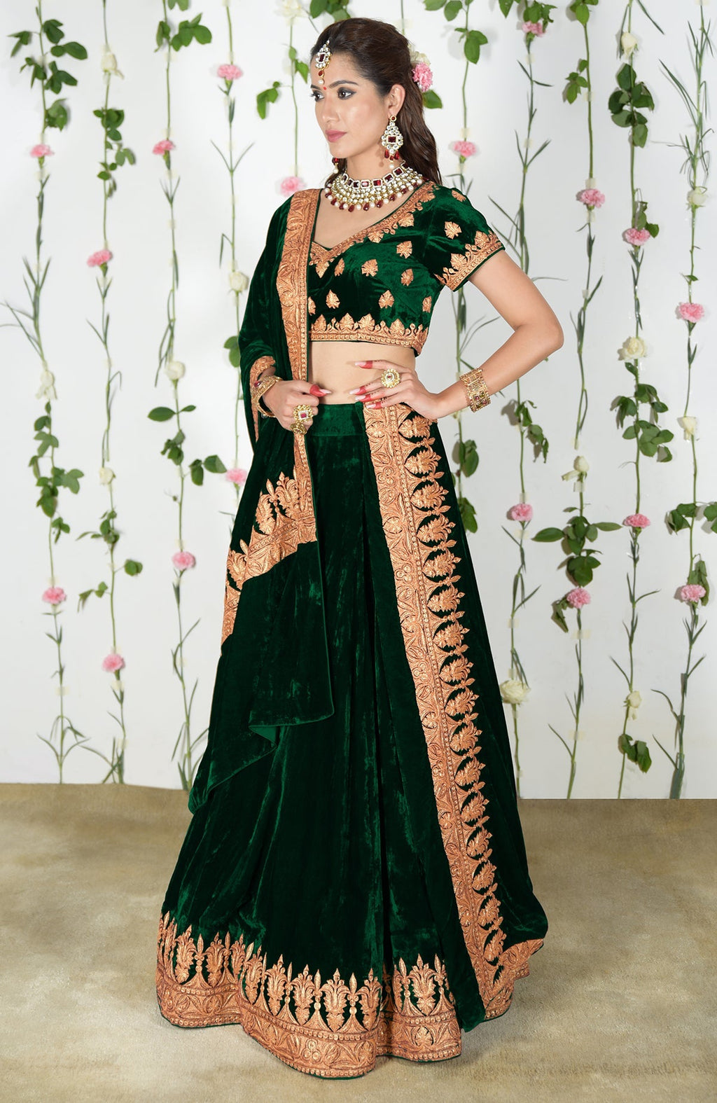 Emerald green velvet lehenga outfit with gold Kashmiri Tilla embroidery.