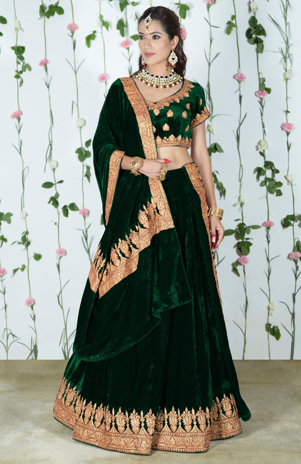 Emerald green velvet lehenga outfit with gold Kashmiri Tilla embroidery.