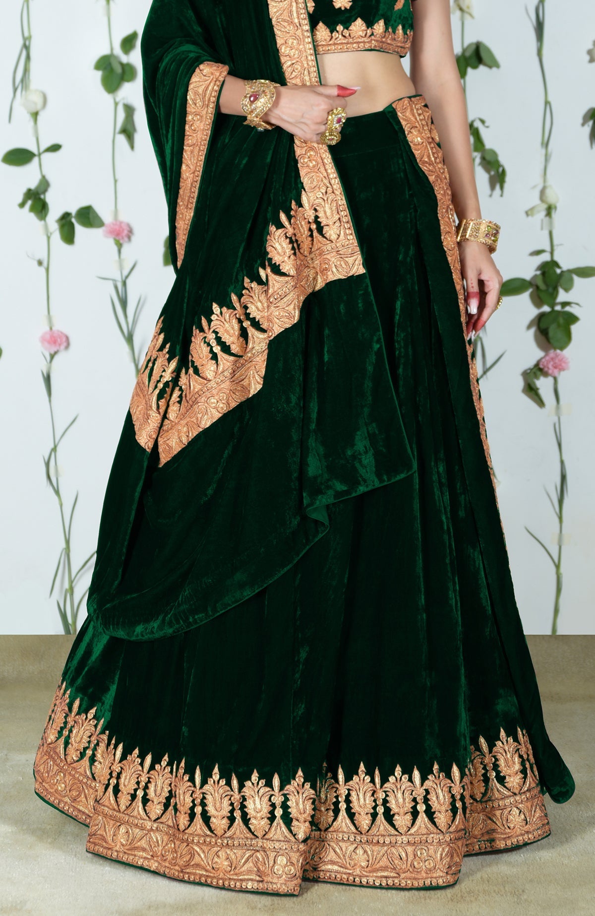 An emerald green velvet lehenga with gold Kashmiri Tilla embroidery.
