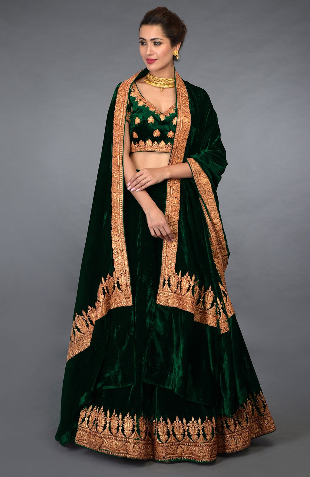 Emerald green velvet lehenga outfit with gold Kashmiri Tilla embroidery.