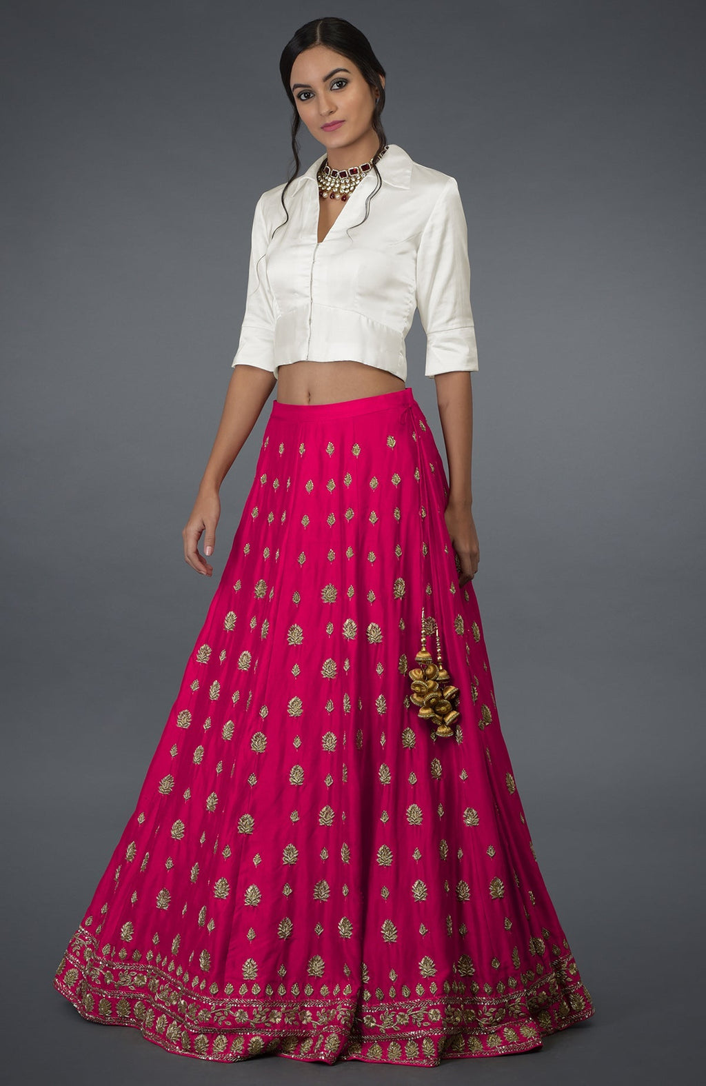 A woman models a berry gloss zardozi and crystal hand-embroidered skirt with an ivory blouse.