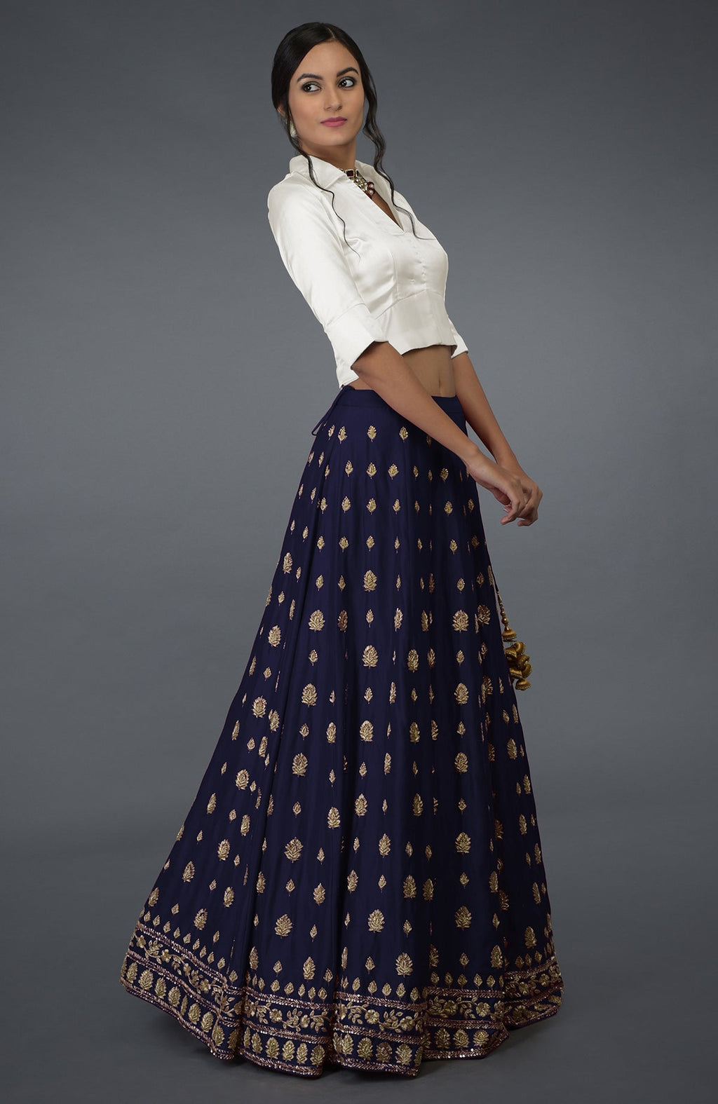 An eclipse blue zardozi and crystal hand embroidered skirt with an ivory satin silk blouse.