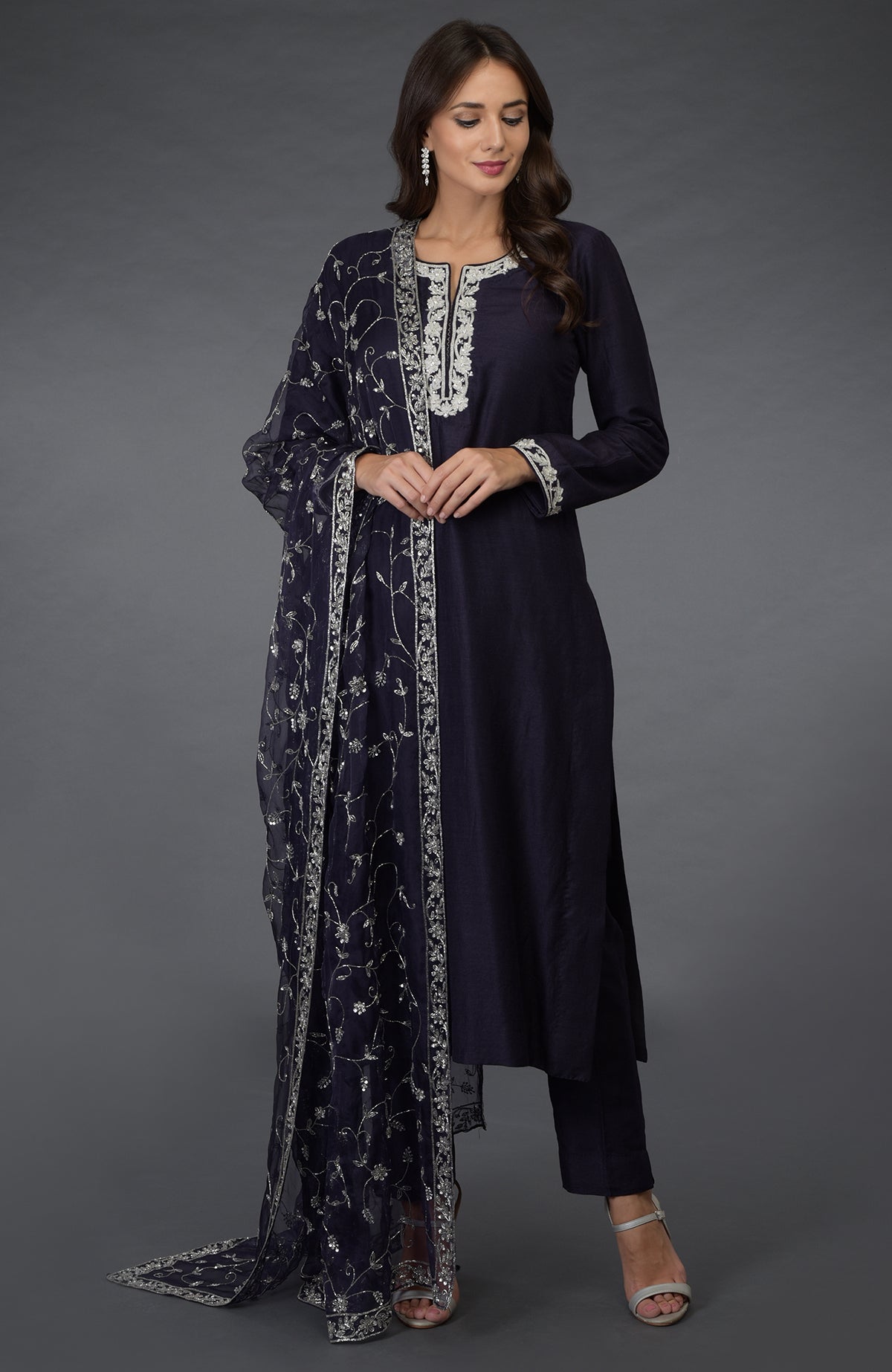 An eclipse blue suit with silver zari, beads, and sequin embroidery.