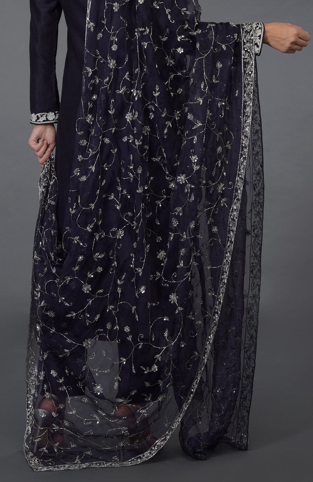 An eclipse blue suit with silver zari, sequin, and crystal embroidery.