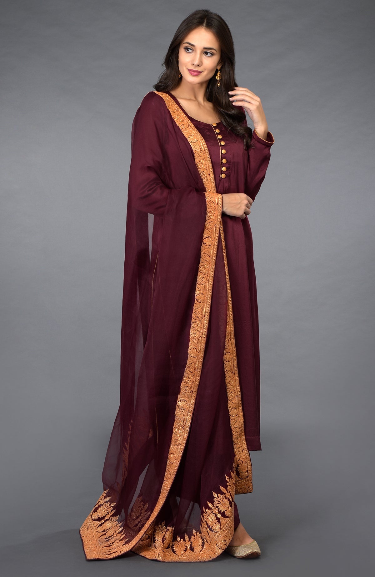 Burgundy salwar pants suit with gold Kashmiri Tilla embroidery and shimmer buttons.