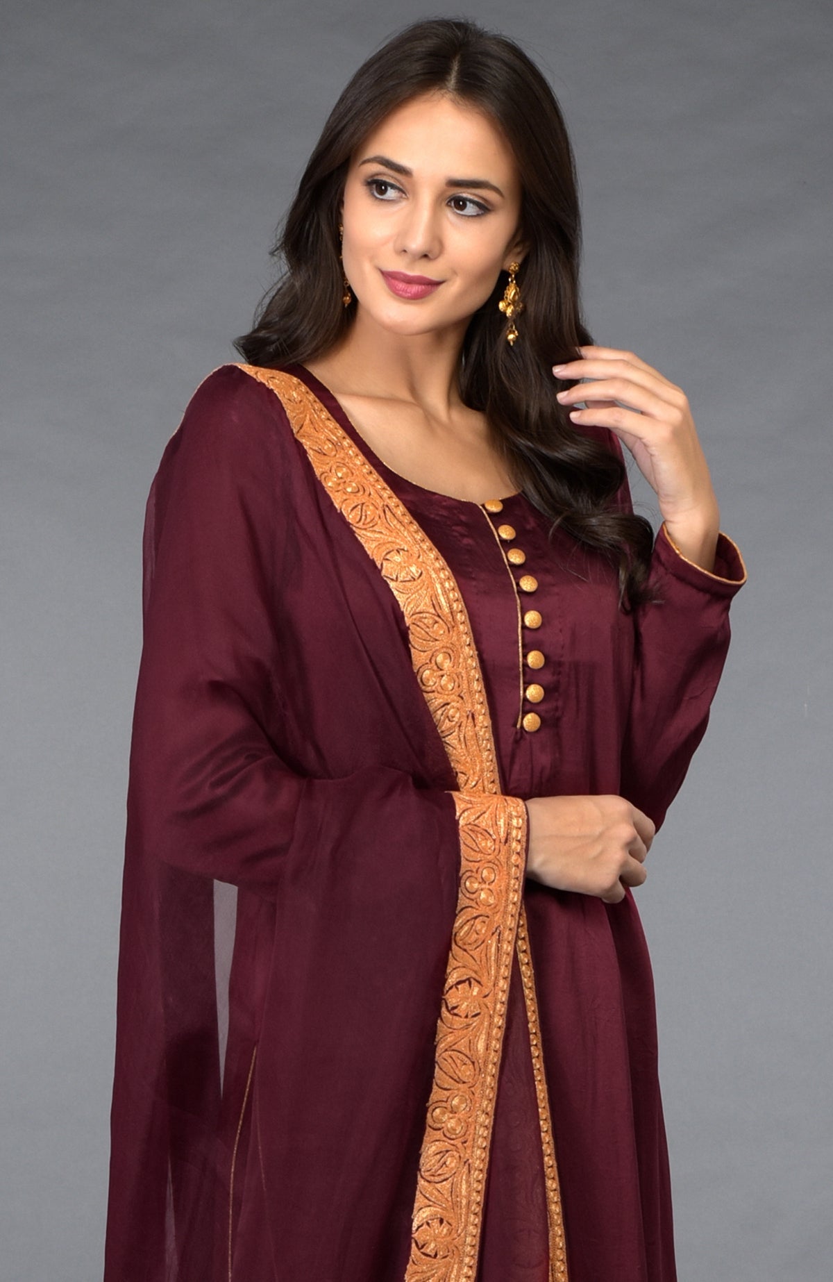 Burgundy Kashmiri Tilla embroidered salwar pants suit with gold buttons and trim.