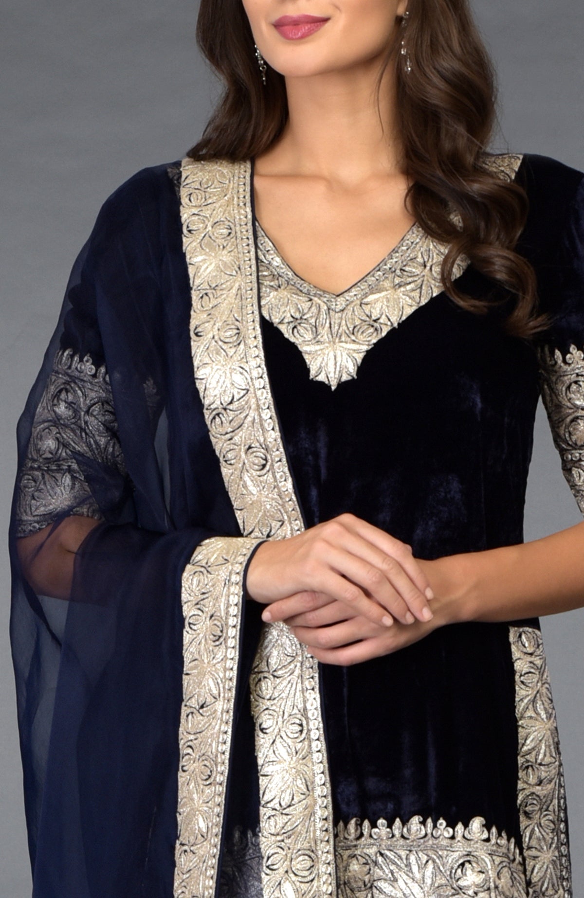 A woman models a midnight blue Kashmiri Tilla embroidered dhoti pants suit.