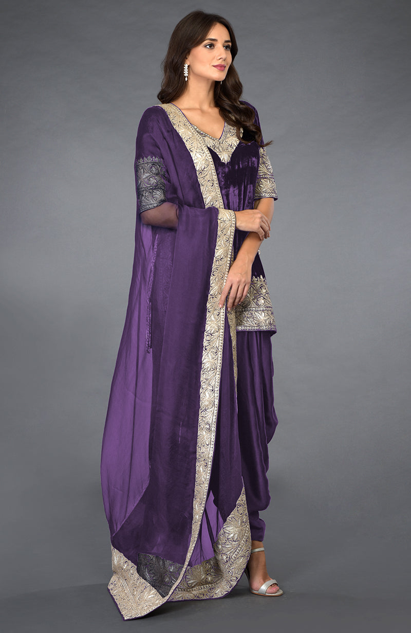A woman models a mulled grape Kashmiri tilla embroidered dhoti pants suit.