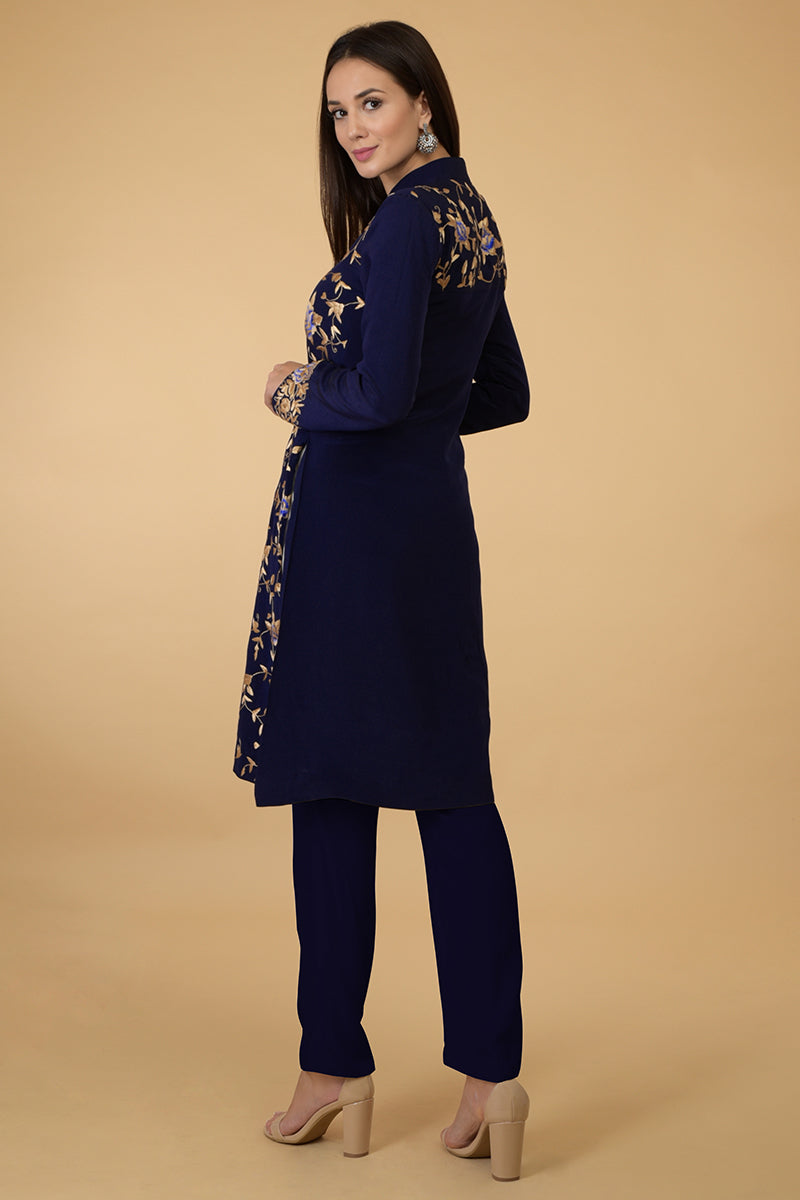 Midnight blue Parsi Gara jacket with floral embroidery, band collar, and matching pants.