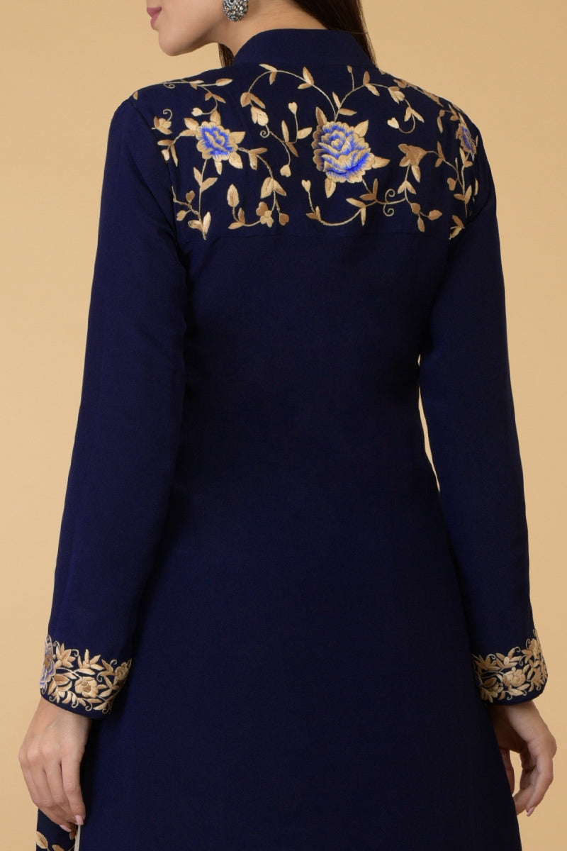 Midnight blue Parsi Gara jacket with floral embroidery, band collar, and matching pants.