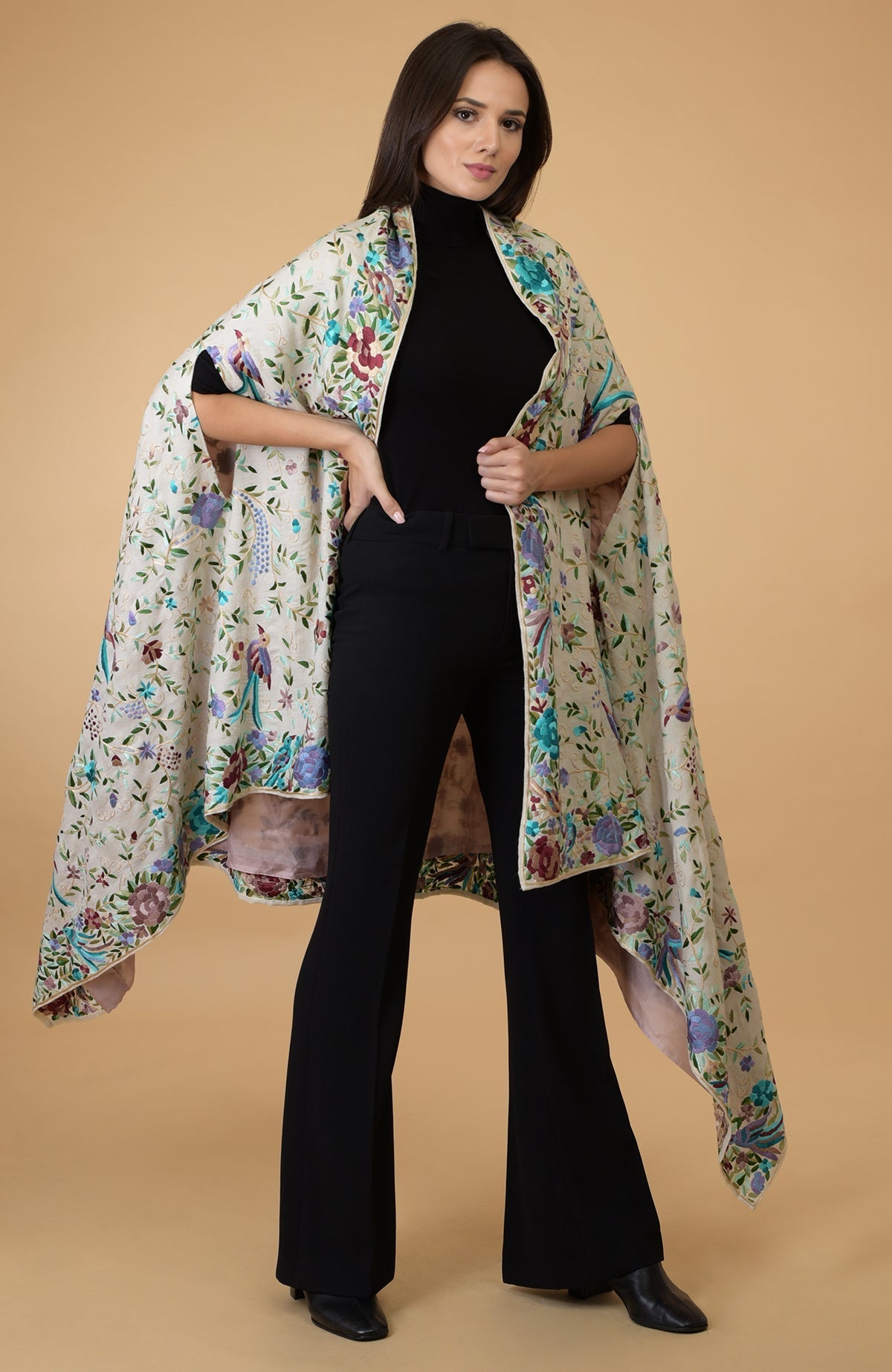 An ivory Parsi Gara pure pashmina shawl cape with intricate bird and floral embroidery.