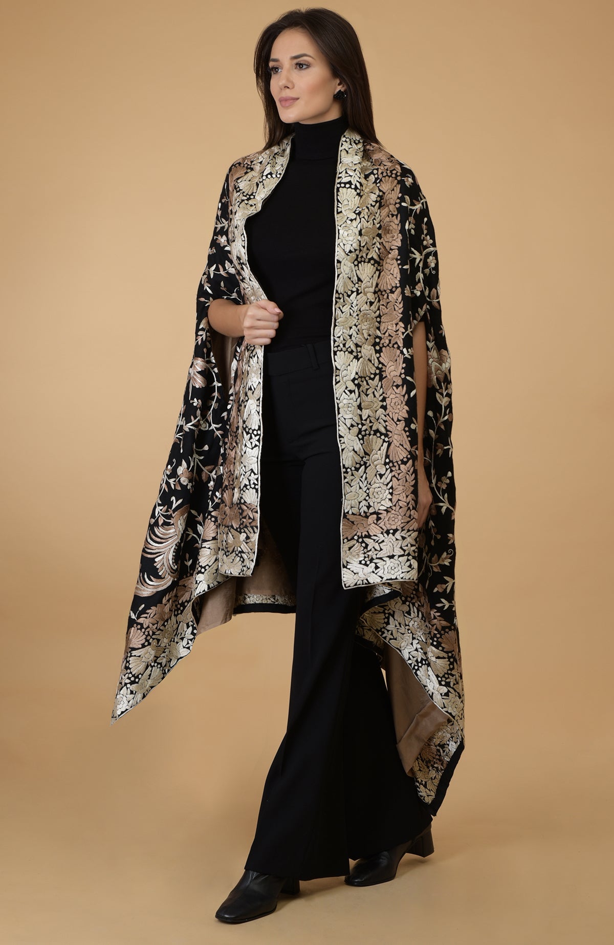 A woman models a black and beige Parsi Gara pure pashmina shawl cape.
