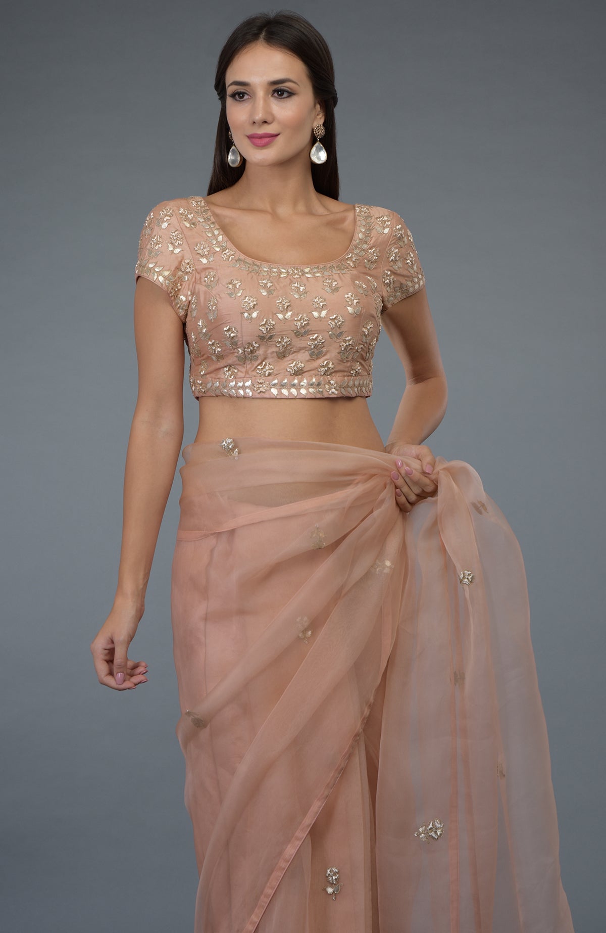 Pressed rose organza silk saree and blouse with zardozi and gota patti embroidery.
