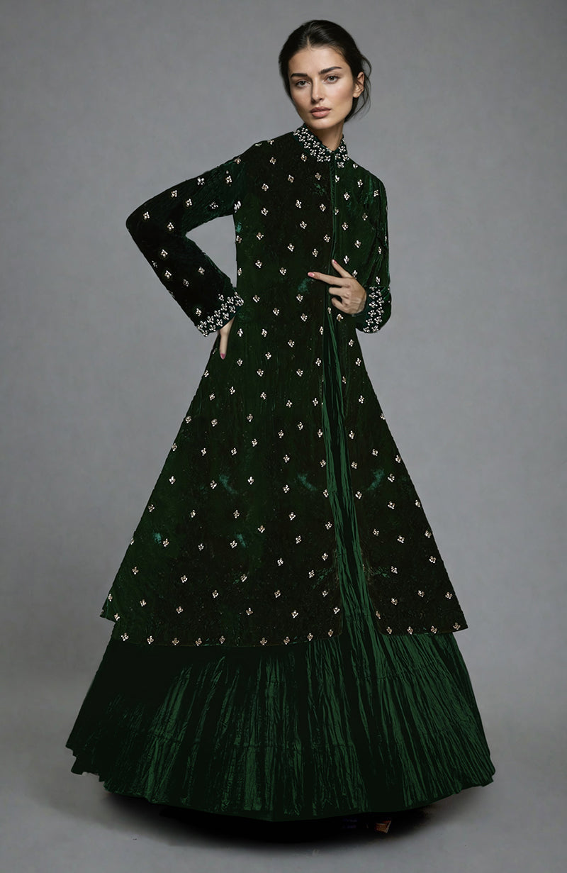 A model wears an emerald green silk-velvet jacket set with crystal embroidery.