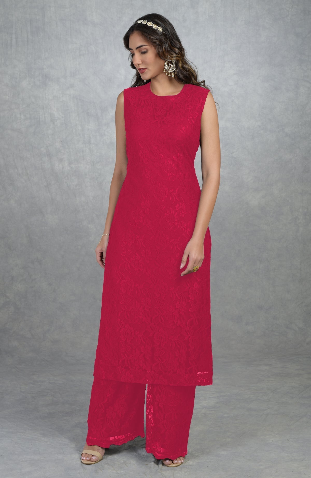 A woman models a red fine lace tunic kurta with wide-leg pants.