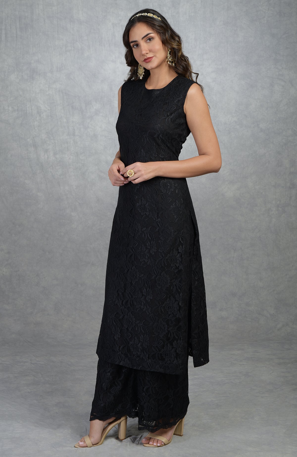 A woman models a black fine lace tunic kurta with wide-leg pants.