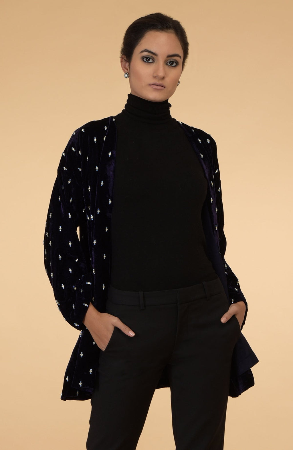 Eclipse blue silk velvet jacket with crystal hand embroidery, worn over a black top and pants.