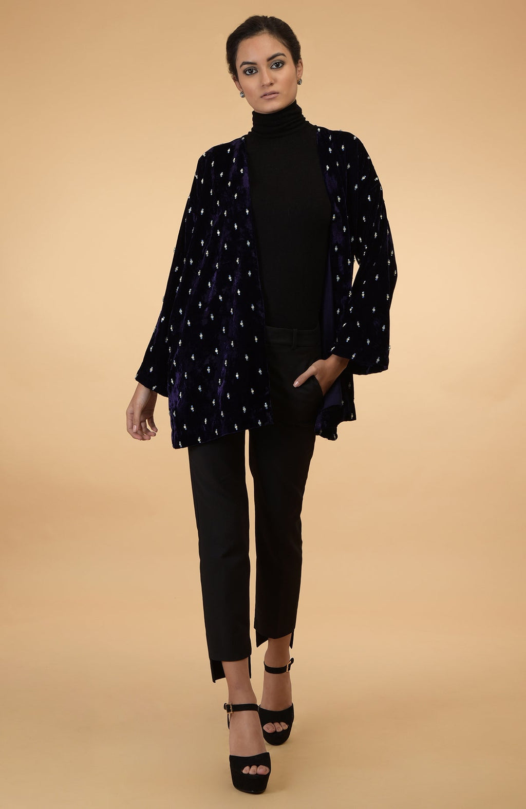 An Eclipse Blue Crystal Hand Embroidered Silk Velvet Jacket is worn by a model.