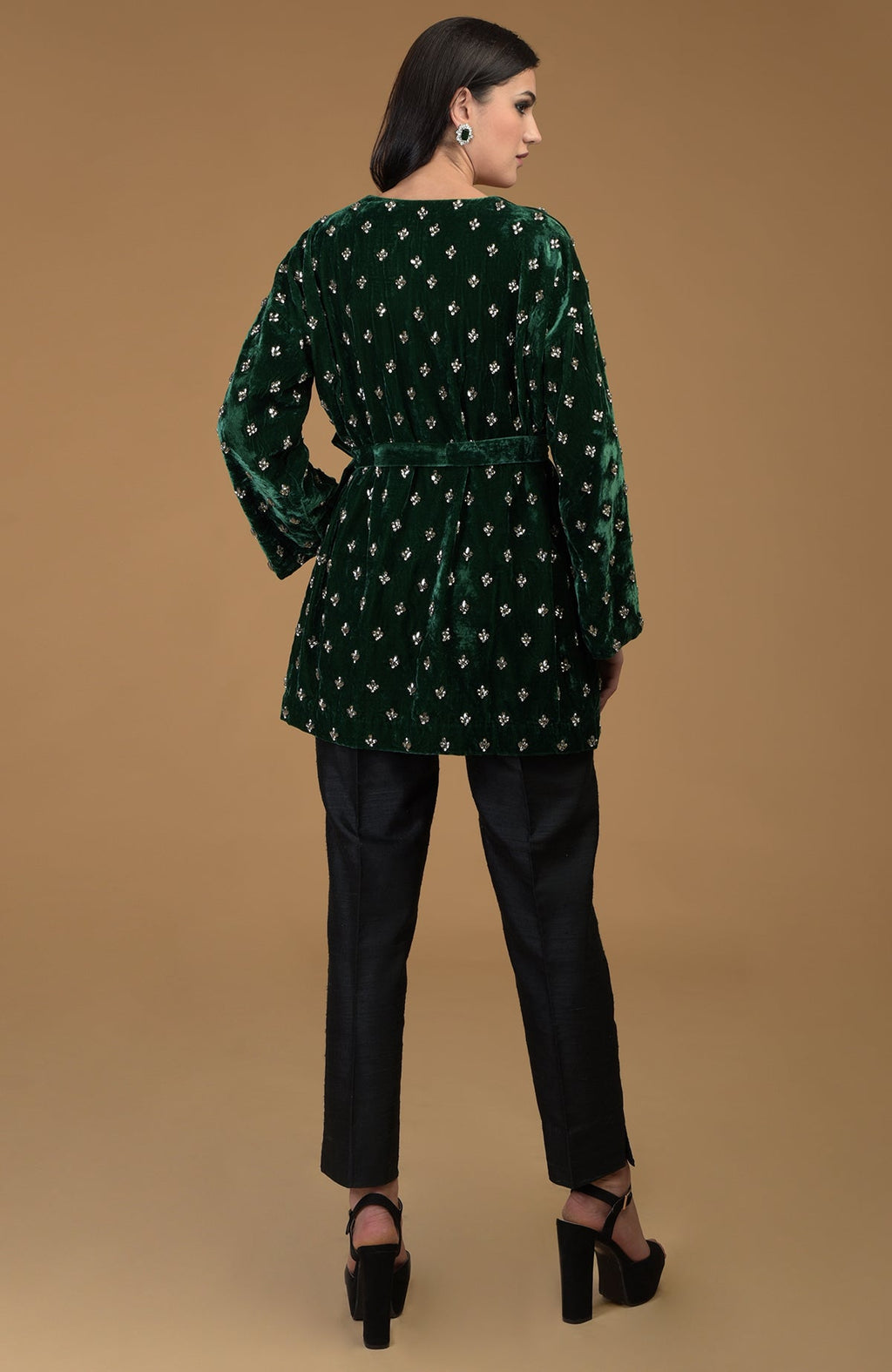 Emerald green crystal hand embroidered silk velvet jacket with a waist belt.