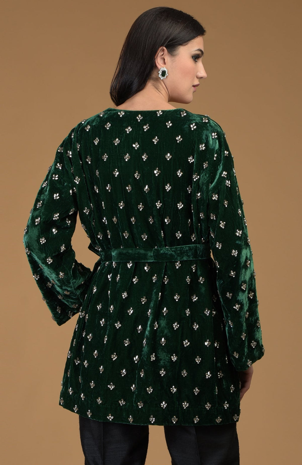 Emerald green silk velvet jacket with crystal hand embroidery and a waist belt.