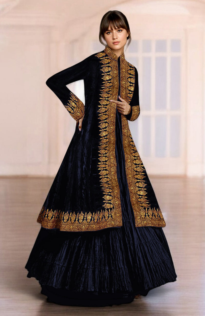 A woman models a midnight blue velvet jacket with gold embroidery and a tiered skirt.