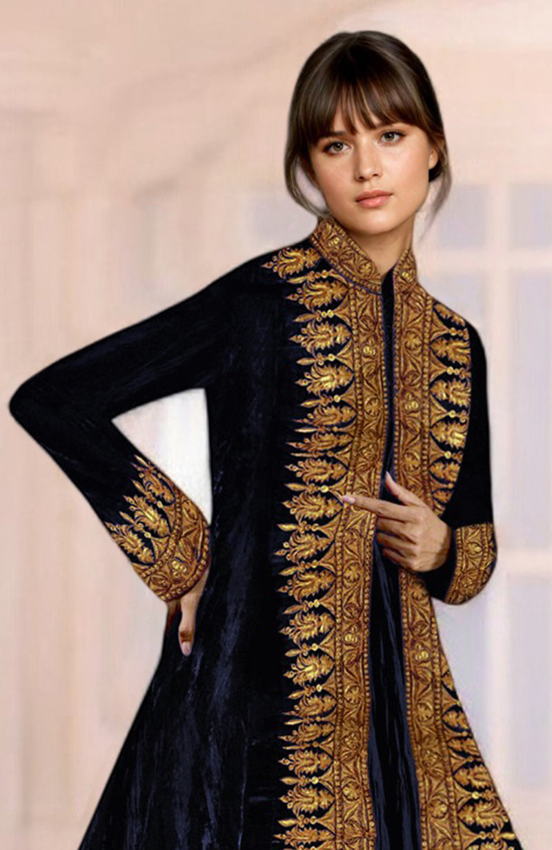 A woman models a black velvet jacket with gold embroidery.